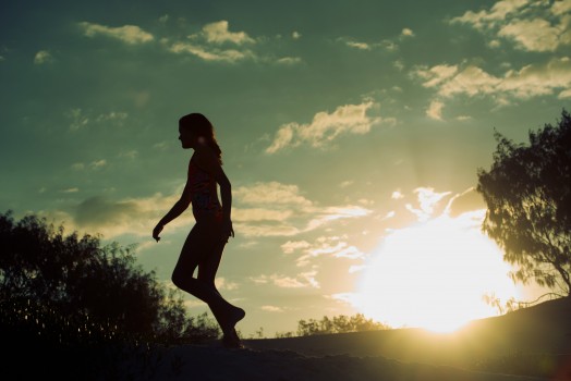 Silhouette of girls walking at sunrise