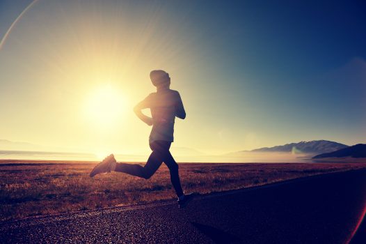 young fitness woman runner running on sunrise seaside trail