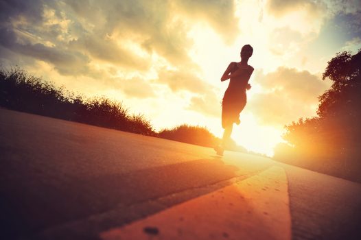 young fitness woman runner running on sunrise trail