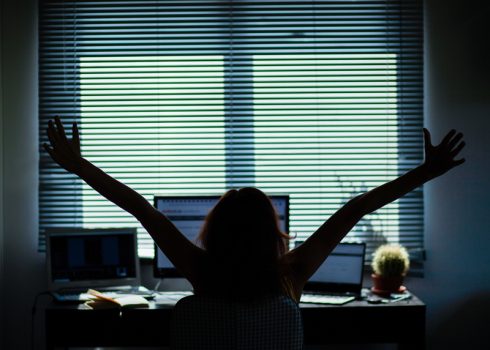 silhouette of a woman working in a home office - social media influence, blogger, vlogger, freedom