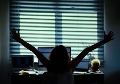 silhouette of a woman working in a home office - social media influence, blogger, vlogger, freedom