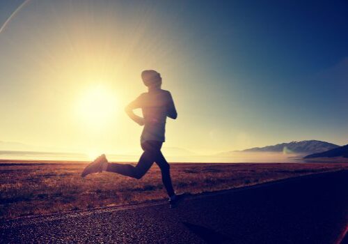 young fitness woman runner running on sunrise seaside trail