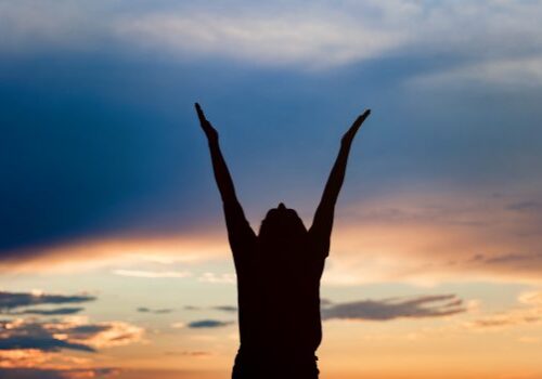 young woman silhouette at sunset